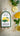 Packaged lemon basil fettuccine with lemons and basil leaves on a textured surface