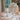 Arte Italica & Crown Linen Designs - Scavo Rose Petal Candle Holder - shown on table with lit candle