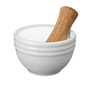 White mortar and wooden pestle on a white background