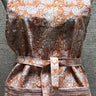 Patterned apron on a mannequin against a neutral background