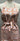 Patterned apron on a mannequin against a neutral background