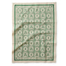 Rifle Paper Co. Artichoke pattern in green and cream on a tea towel.