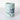 Ceramic mug with bird and wave design on a light blue background