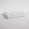 White folded set of sheets with one corner pulled back
