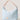 Light blue handbag with beige strap and logo on a light background
