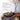 Rustic farm table with a wooden bowl and harvest salad, fresh vegetables.  A large vase with natural branches with orange berries. Glassware and silverware accompanies linens. James Beard Award Winner badge. 