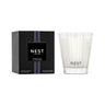 Nest New York’s Cedar Leaf & Lavender Collection Candle and Packaging. Candle features Nest’s signature etched glass candle holder and black packaging with purple stripe.