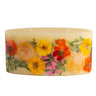 Rosy Rings Statement Candle shown in ‘Sugared Citrus’ fragrance. Candle features dried flowers in yellows, oranges and pinks with dried citrus slices throughout.