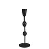 A black metal candlestick holder with a unique sculptural design featuring three rounded bulbous sections on a slender stem, set against a plain white background.