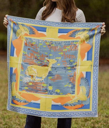 Model holds scarf aloft