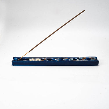 Incense holder with incense stick on a white background