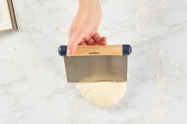 Zyliss Bench Scraper with Measurement Markings Shown used to cut dough