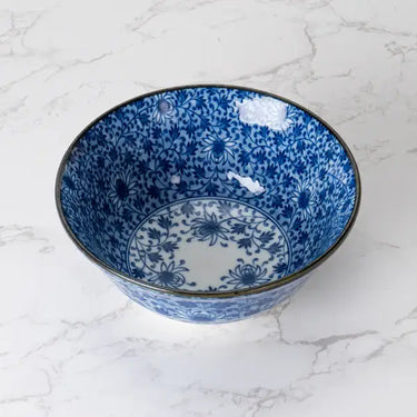 Blue and white ceramic bowl on a marble surface