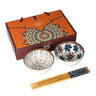 Two decorative bowls with floral patterns, a set of chopsticks, and a branded box on a white background.