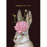 Greeting card with a rabbit's head featuring a pink flower and the text 'Thinking of You' on a dark background.