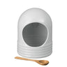 White ceramic salt pig with a wooden scoop on a white background